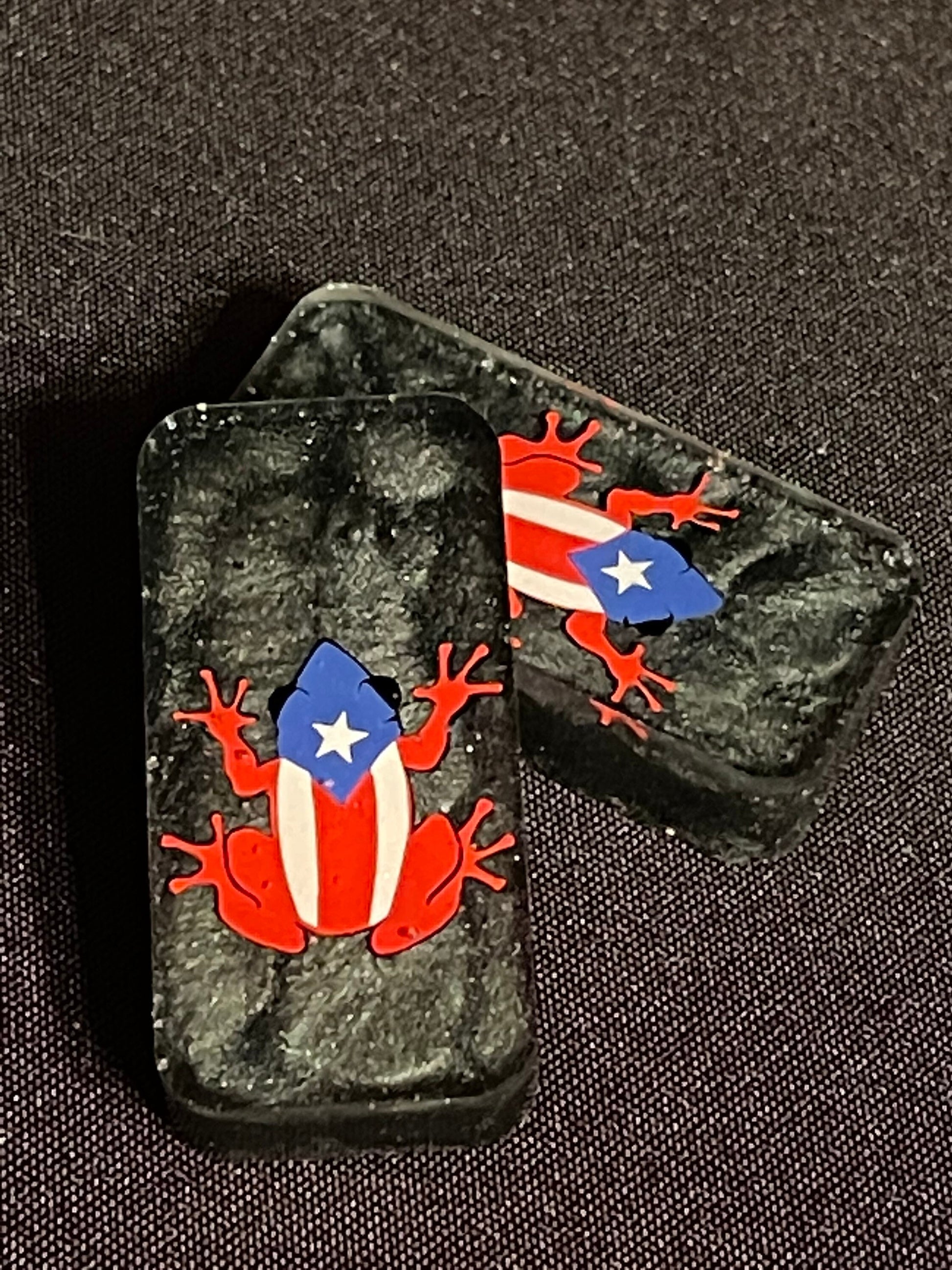 2 Black Coqui dominoes showing the design upclose