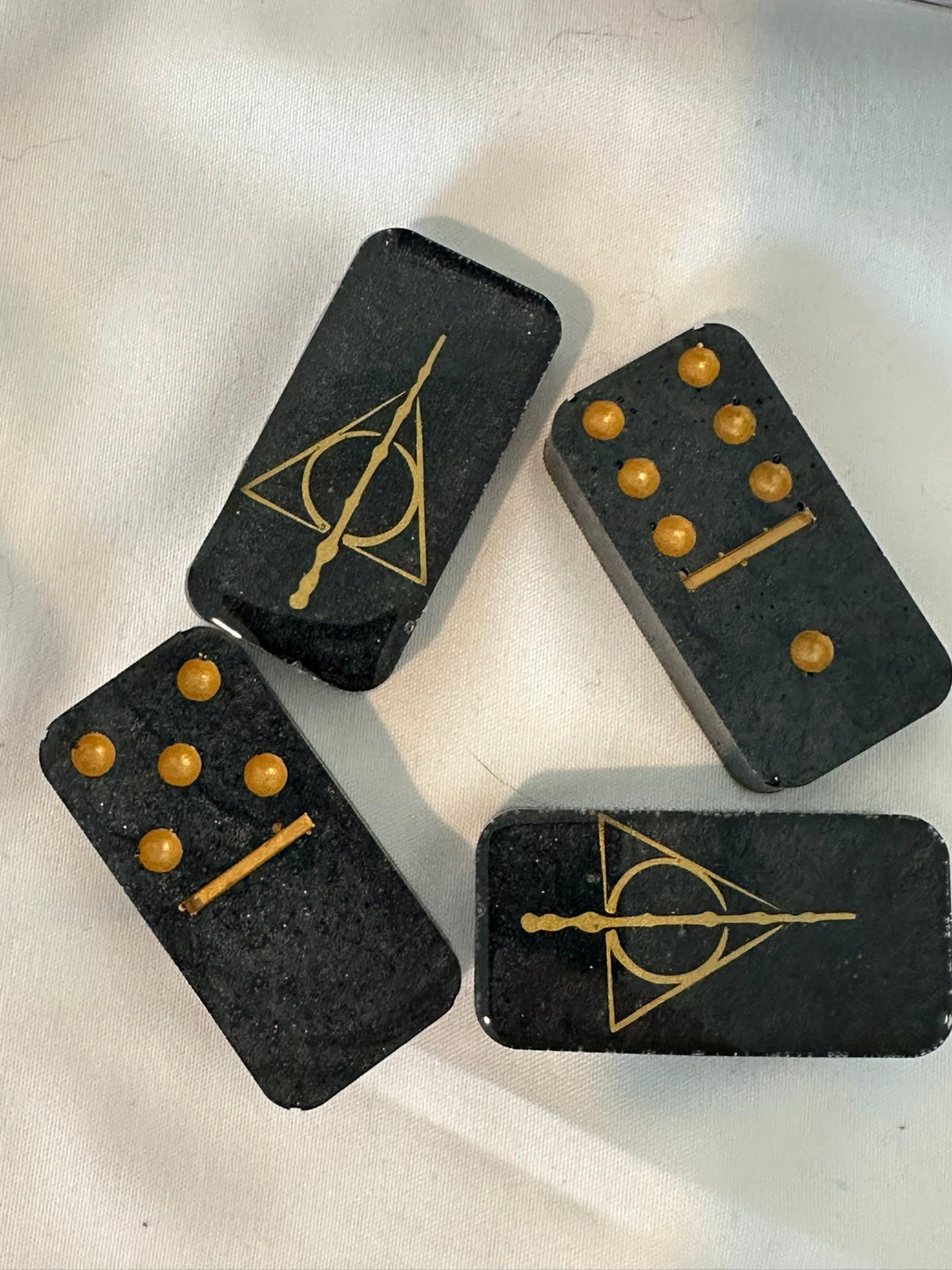 Closeup shot of the Deathly Hallows Dominoes Showcasing the gold lines and dots as well as the Gold Deathly Hallows symbol