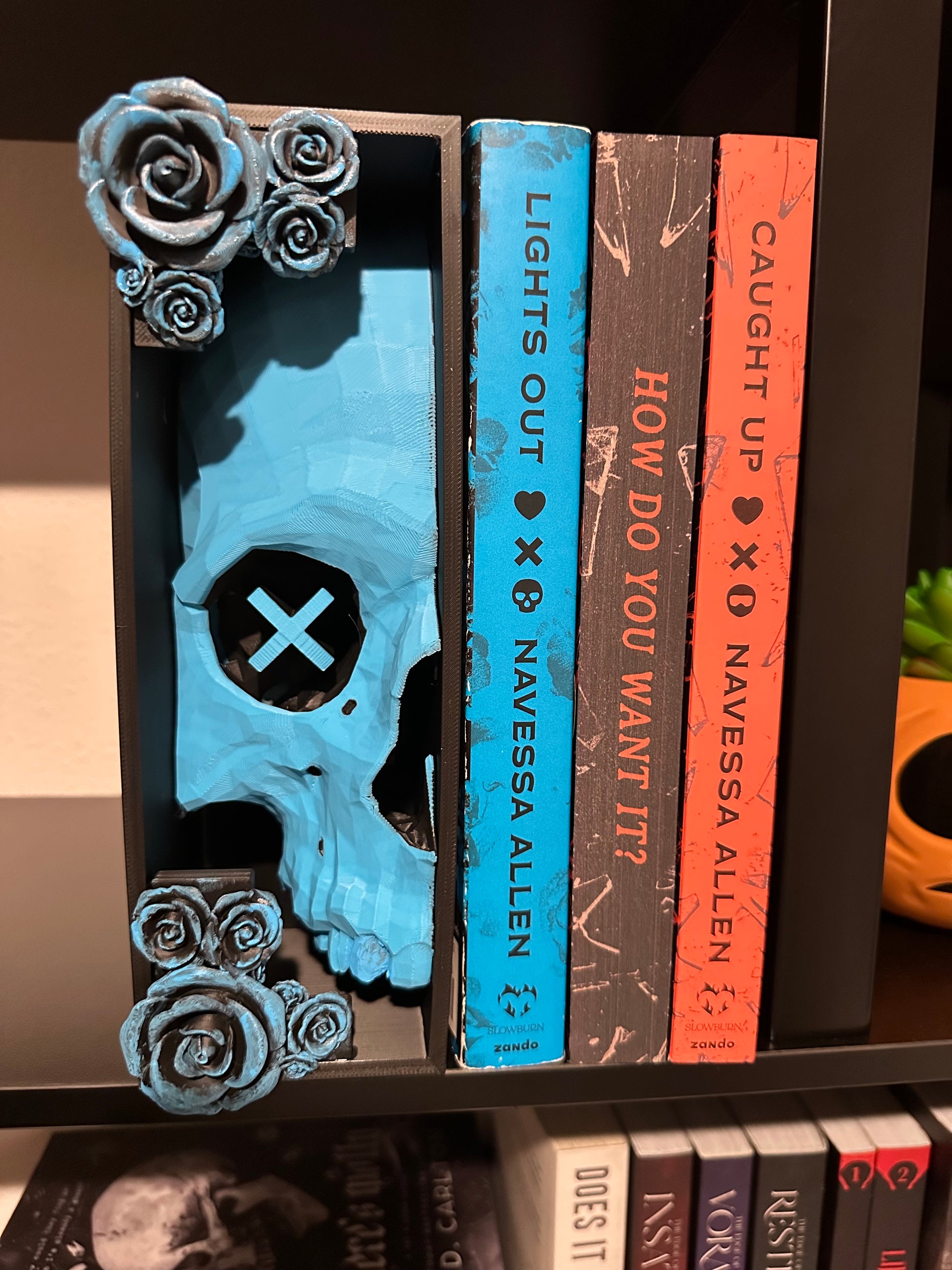 Left side (X) Book nook holding some books on a bookshelf