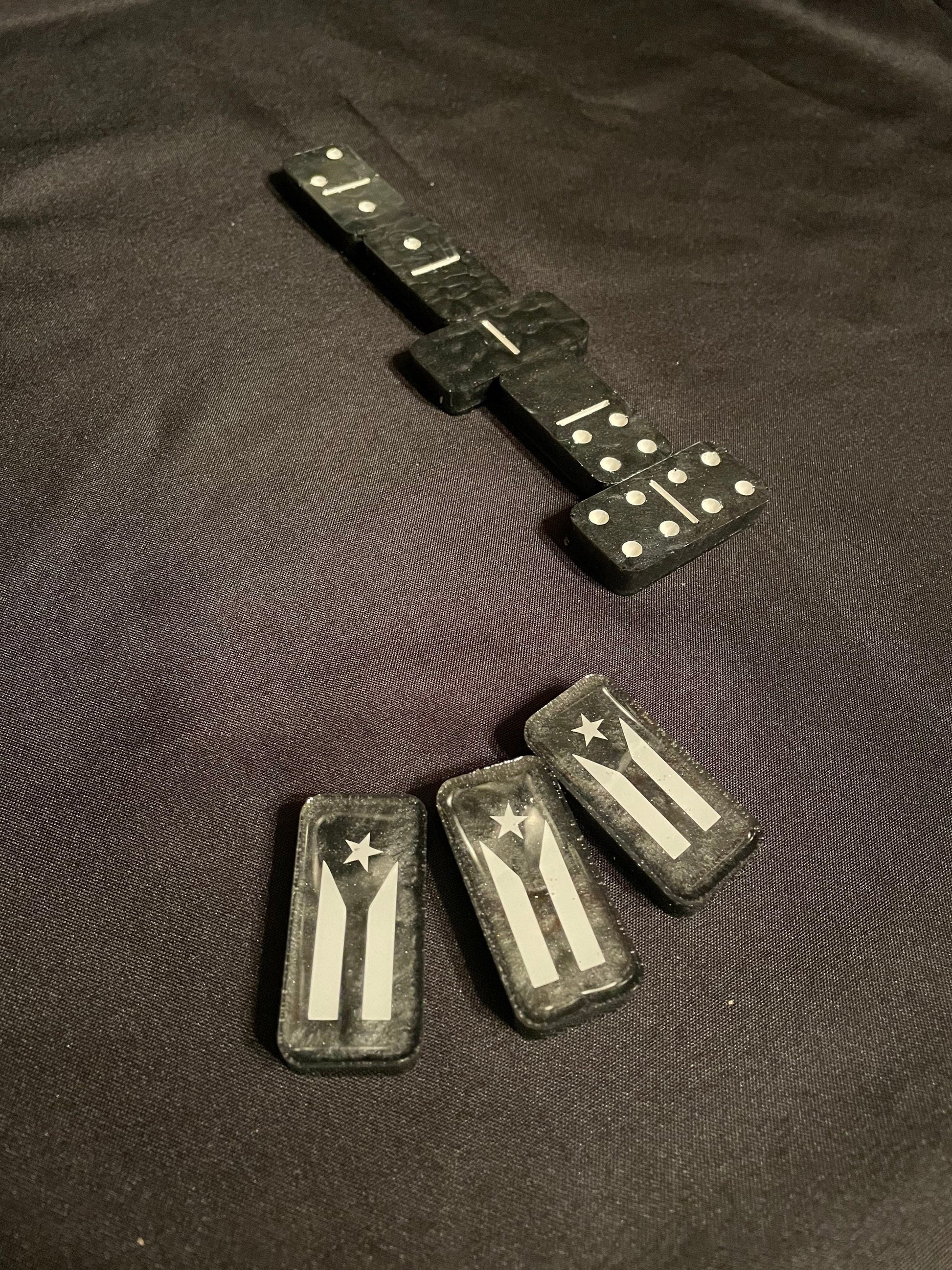 Top down view of the Puerto Rico dominoes showing the dots and lines as well as the design of the Resistance flag