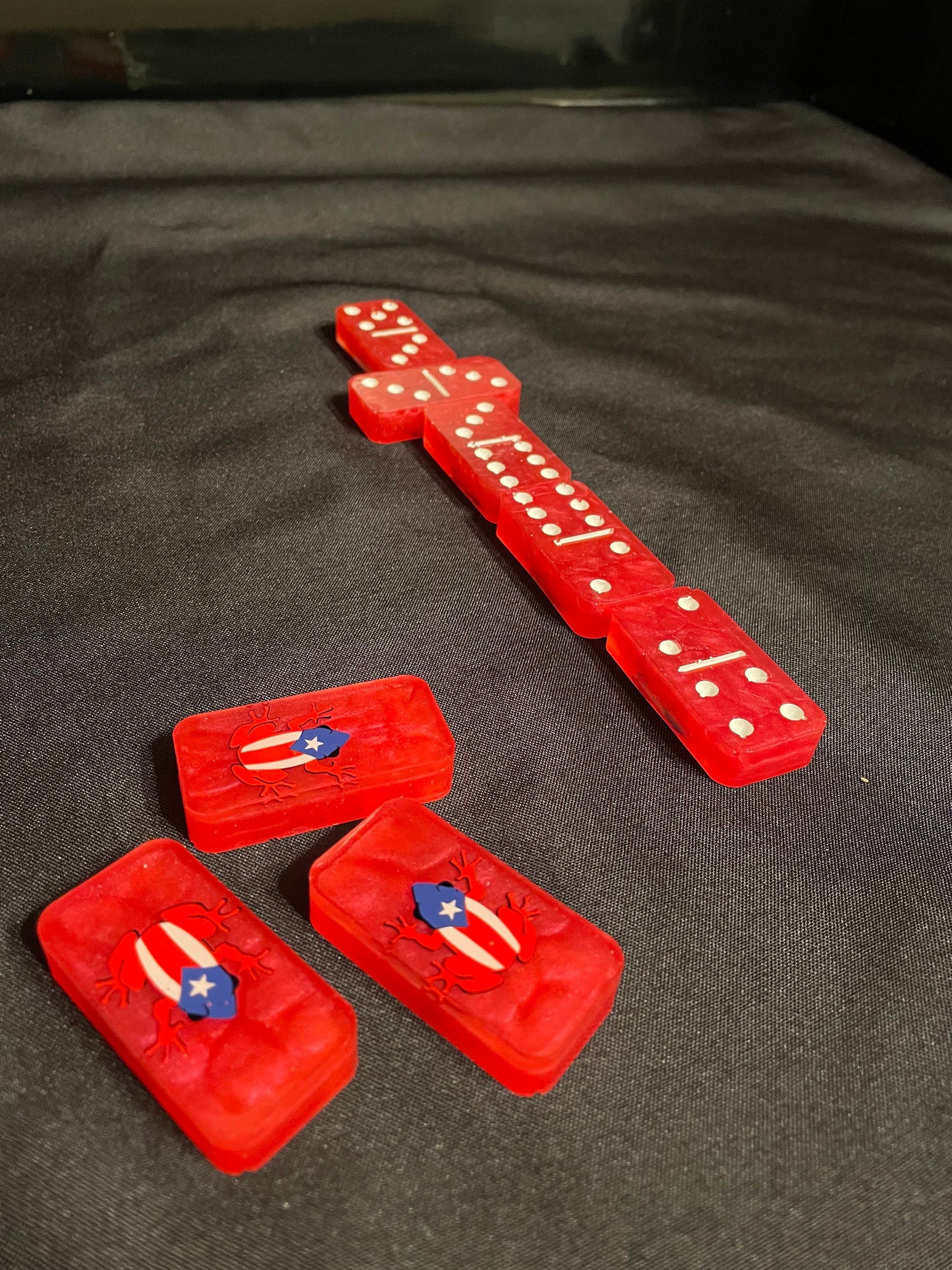 Red Coqui Dominoes showing off the dots and lines and the design