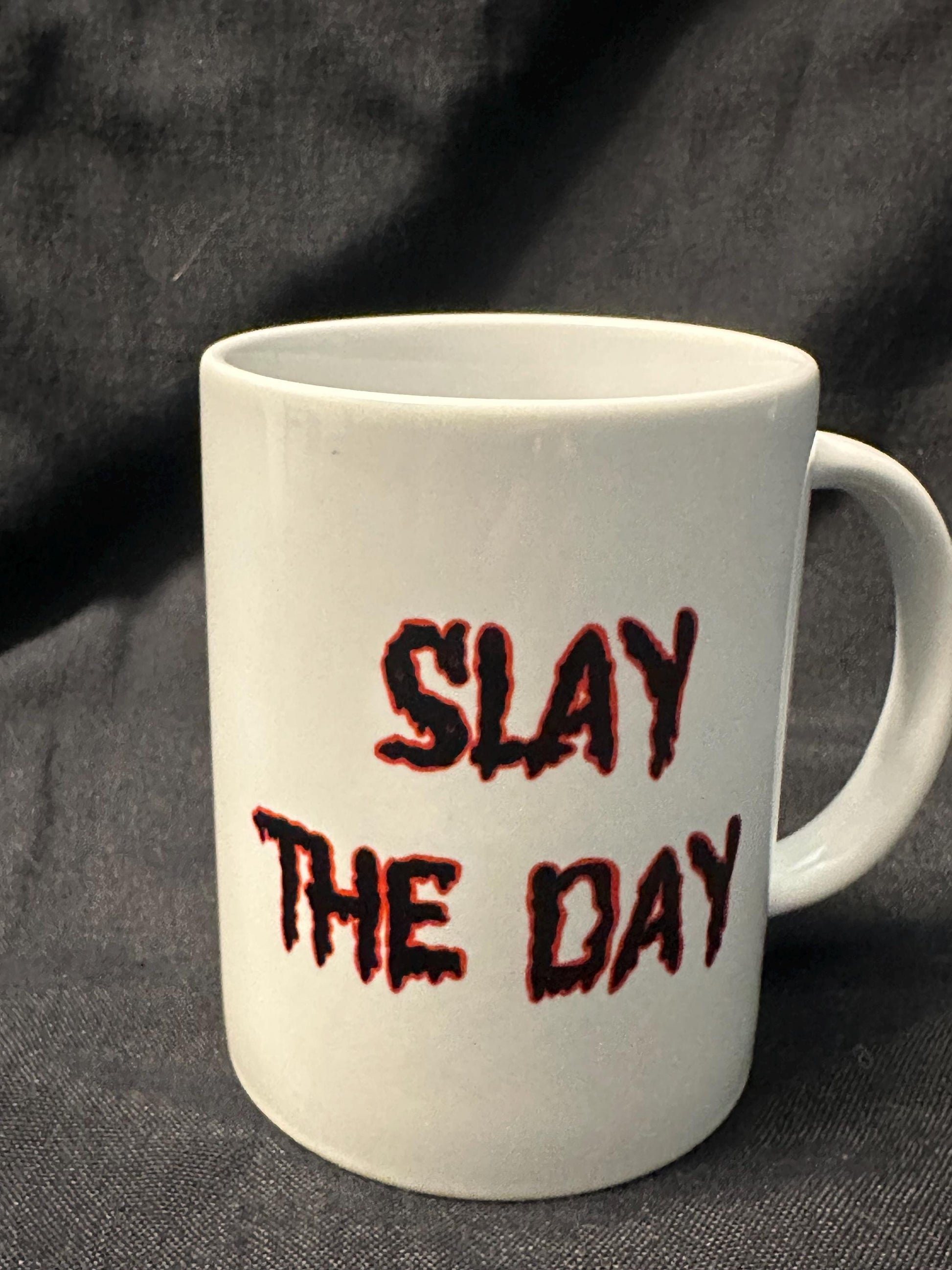 Slay the Day prominently displayed in a dripping font in black with a red outline