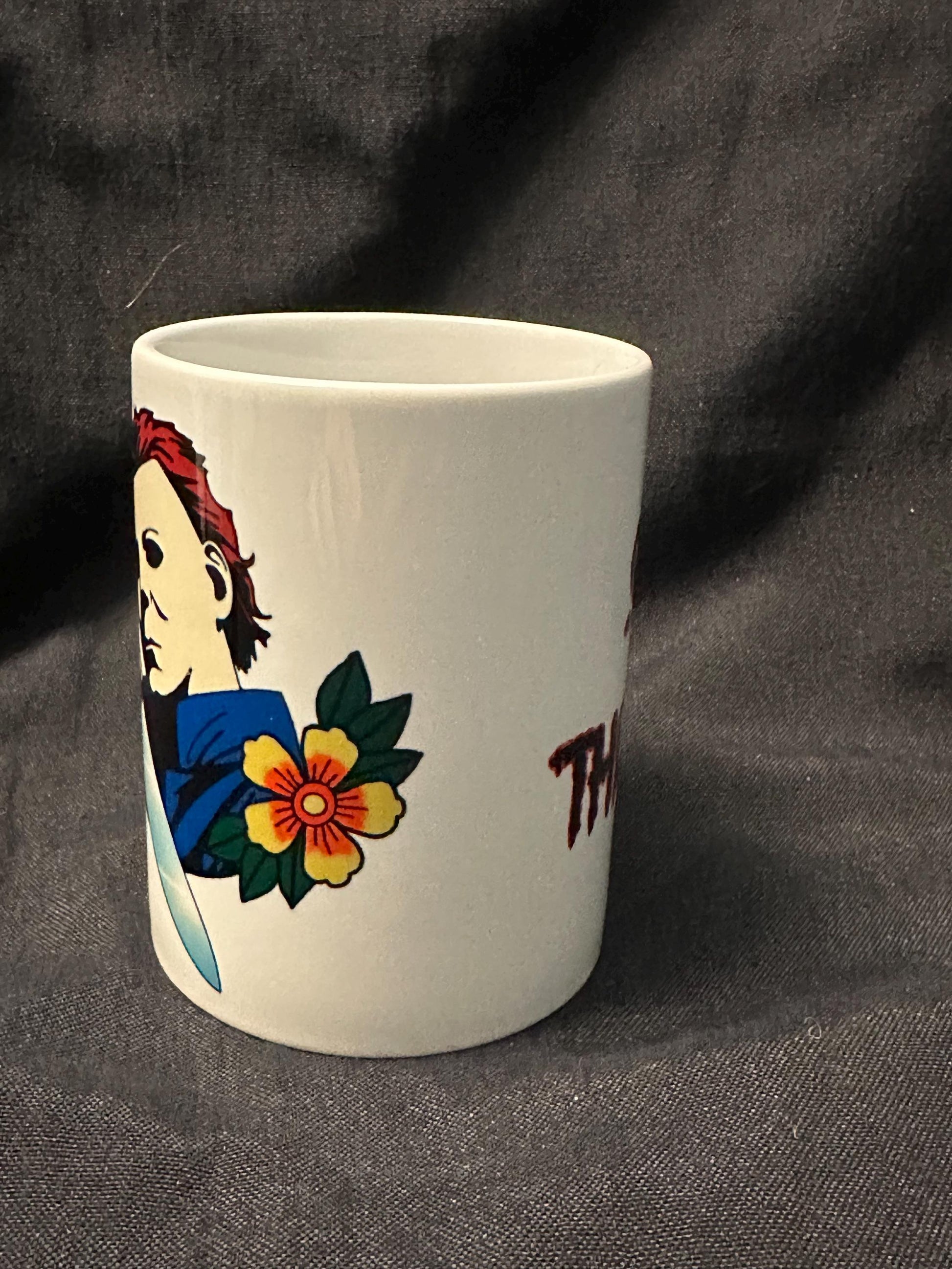 Michael Myers on the left and Slay the Day on the right of the mug