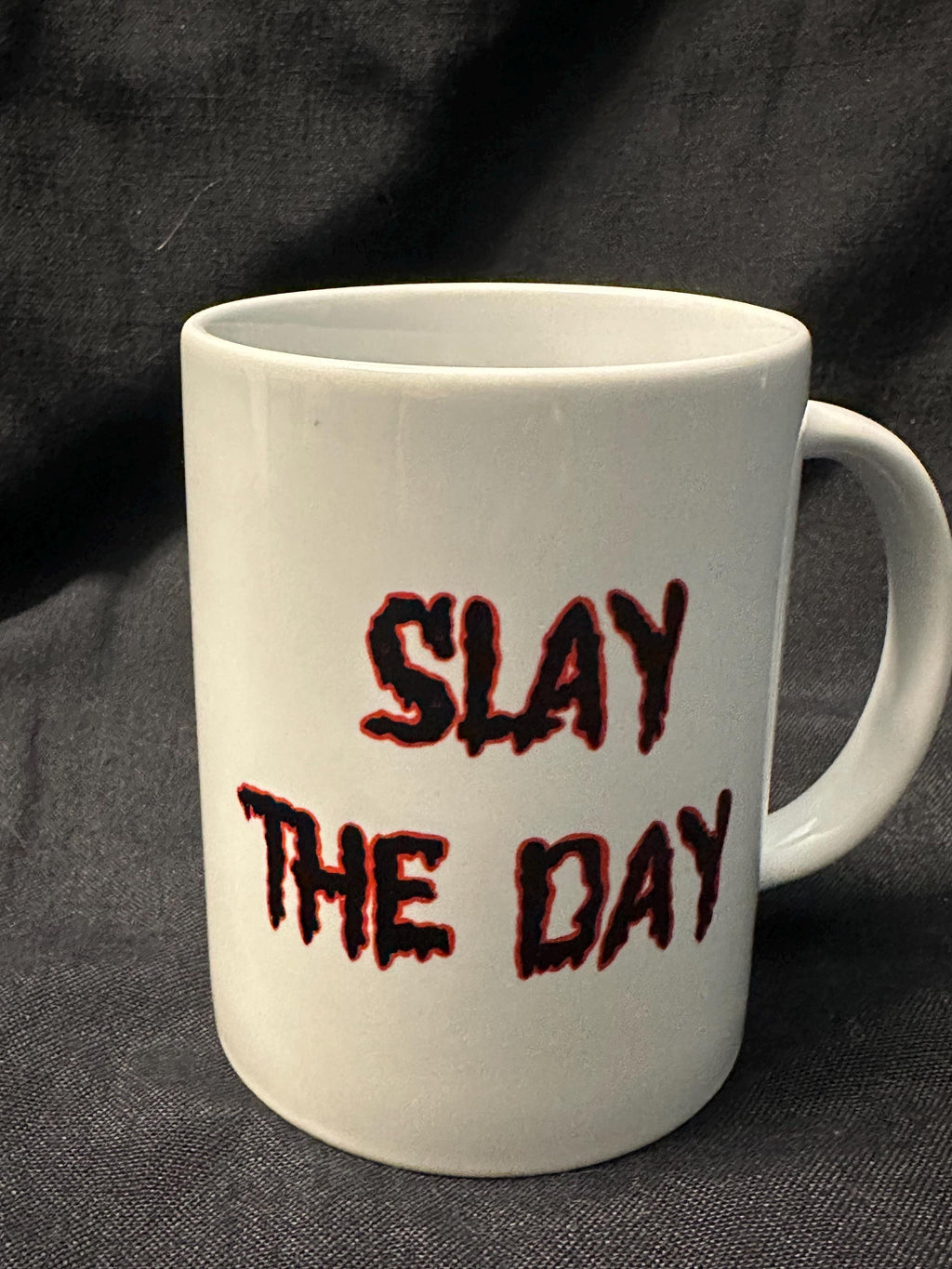 Slay the Day prominently displayed in a dripping font in black with a red outline